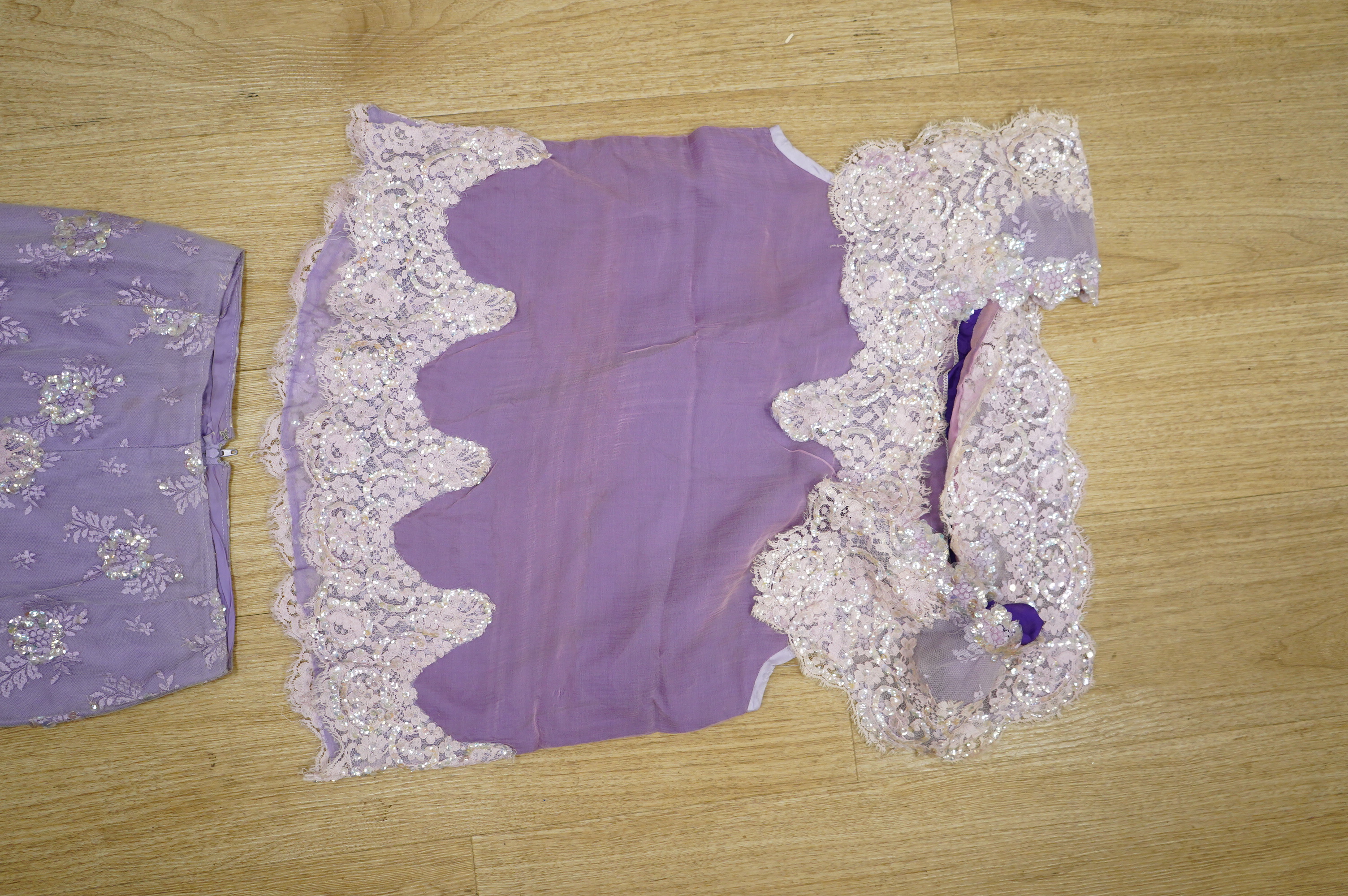 A late 20th century black sequinned, beaded and fringed evening dress, bust 36cm wide at front, together with a lilac chiffon, net, lace and sequin top and matching net evening skirt. Both outfits are a small size